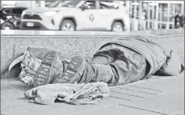  ?? ?? He needs more than a home: A vagrant lies strewn in Times Square.