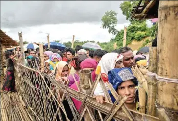  ?? AFP ?? Rohingya refugees queue at an aid relief distributi­on centre at the Balukhali refugee camp near Cox’s Bazar. The UN has urged Bangladesh to halt plans to start returning Rohingya refugees to Myanmar.