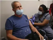  ?? NAnCy LAnE / HERALD STAFF FILE ?? GETTING VACCINATED: Whittier Street Health Center licensed practical nurse Jennifer Cox administer­s the COVID-19 vaccine to Orisle Ruiz at the city’s Paulette Ford Community Center on March 22.