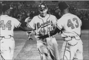  ?? PHOTO COURTESY OF DELAWARE COUNTY HISTORICAL SOCIETY ?? In this Associated Press photo from 1959, Braves infielder Mickey Vernon is greeted at home by Wes Covington, right, and Hank Aaron after hitting a home run. The Delaware County Historical Society’s Museum will host a year-long celebratio­n to honor Vernon.