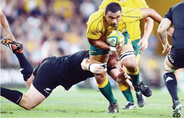  ?? — EPA ?? Going through: Australia’s Wycliff Palu (centre) tries to go past the New Zealand defenders in the Bledisloe Cup match at Suncorp Stadium in Brisbane yesterday. The match ended 18-18.