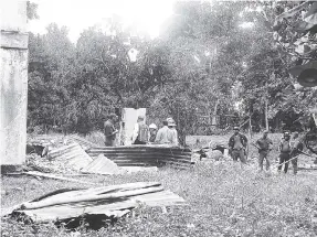  ?? PHOTO BY SUGAR RAY THOMAS ?? Police conduct a search of the property in Lime Hall, St Ann.