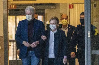  ?? AP ?? OUT: Former President Bill Clinton and former Secretary of State Hillary Clinton leave the University of California Irvine Medical Center in Orange, Calif., Sunday. He was released after being treated for an infection and went home to New York to continue his recovery.