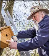  ??  ?? One of the bird boxes is placed into position