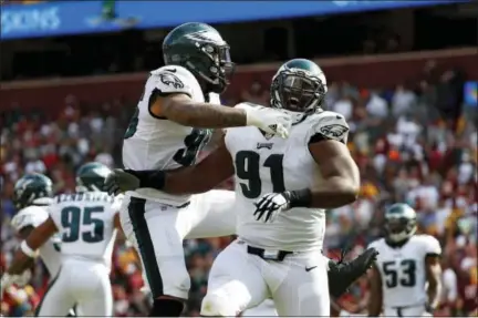  ?? ALEX BRANDON — THE ASSOCIATED PRESS ?? Philadelph­ia Eagles defensive tackle Fletcher Cox, right, celebrates with Derek Barnett after officials reviewed and confirmed a play in which Washington Redskins quarterbac­k Kirk Cousins fumbled and Cox recovered and scored a touchdown in the second...