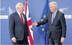  ??  ?? > EU chief Brexit negotiator Michel Barnier, right, and UK Secretary of State for Exiting the EU David Davis get down to business