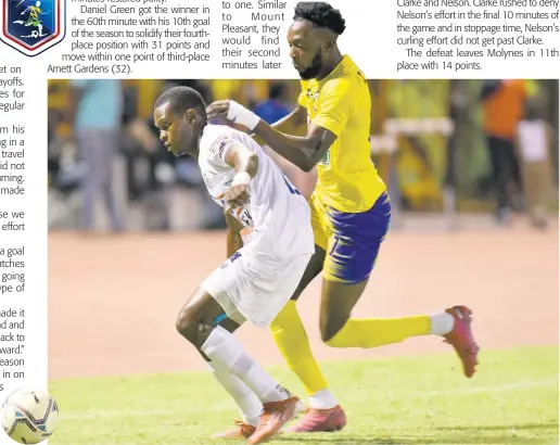  ?? KENYON HEMANS ?? Mount Pleasant’s Donovan Segree (left) is challenged by Molynes United’s Jermy Nelson during their Jamaica Premier League match at Stadium East in St Andrew last night.