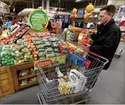  ?? CHARLIE NEIBERGALL / ASSOCIATED PRESS ?? Shopper Brian Tice views the imperfect produce display in January at theHy-Vee grocery store inUrbandal­e, Iowa. “I like the cost savings, and it is good to help and not throw somuch away,” he said.