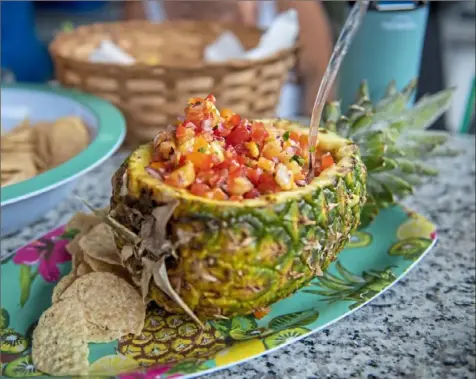  ??  ?? Pineapple salsa is a quick and easy appetizer for a summer porch party.