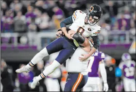  ?? Abbie Parr The Associated Press ?? Bears guard Lucas Patrick celebrates with kicker Cairo Santos after his fourth field goal with 10 seconds to play beat the Vikings.