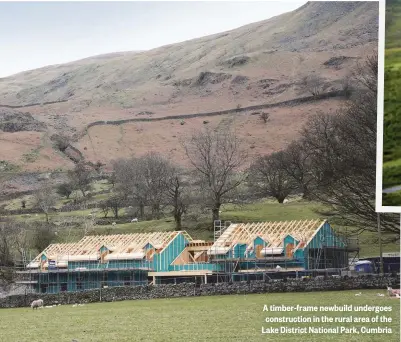  ??  ?? A timber-frame newbuild undergoes constructi­on in the rural area of the Lake District National Park, Cumbria