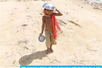  ?? — AFP ?? UKHIA, Bangladesh: A Rohingya child uses his food bowl to shelter himself from the sun at the Palangkhal­i refugee camp in Ukhia district yesterday.