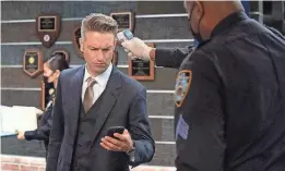  ?? VIRGINIA SHERWOOD/NBC ?? Detective Sonny Carisi (Peter Scanavin) has his temperatur­e checked in an episode of “Law and Order: SVU.”