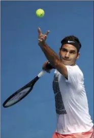  ?? NG HAN GUAN — THE ASSOCIATED PRESS ?? Roger Federer serves during a practice session ahead of the Australian Open in Melbourne, Australia on Jan. 12.