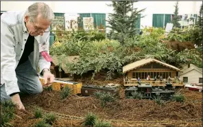  ?? Arkansas Democrat-Gazette/CELIA STOREY ?? Richard Davis keeps his trains running on time in the Central Arkansas Model Railroad Club display during the 2018 Arkansas Flower &amp; Garden Show.