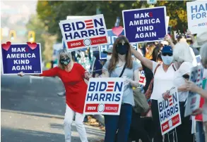  ?? ( George Frey AFP via Getty Images/ JTA) ?? SUPPORTERS OF Democratic presidenti­al candidate Joe Biden show their support before the vice presidenti­al debate outside Kingsbury Hall at the University of Utah in Salt Lake City, earlier this month.