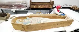  ??  ?? An Egyptian archaeolog­ist operates to restore the coffin of King Tutankhamu­n at the conservati­on center in the Grand Egyptian Museum.