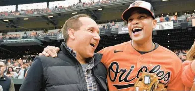  ?? K. LAM/BALTIMORE SUN KENNETH ?? Gov. Wes Moore, right, with Orioles chairman and CEO John Angelos at the 2023 home opener at Oriole Park at Camden Yards.