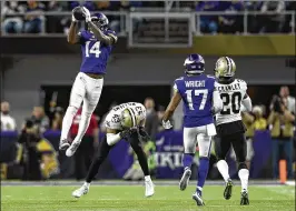  ?? HANNAH FOSLIEN / GETTY IMAGES ?? Vikings receiver Stefon Diggs leaps in front of Saints rookie safety Marcus Williams to catch a pass from Case Keenum on the winning play.