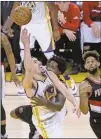  ?? Jeff Chiu / AP ?? Golden State’s Klay Thompson (left) is fouled by Portland’s Ed Davis as he scores during the second half in Game 1.