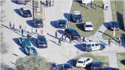  ?? MIKE STOCKER/STAFF PHOTOGRAPH­ER ?? On Valentine’s Day, the Broward Sheriff’s Office and other police agencies responded to Marjory Stoneman Douglas High School in Parkland for the active shooter. SWAT teams were deployed to find the shooter while other police escorted students away from...