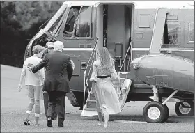  ?? AP/CAROLYN KASTER ?? President Donald Trump boards Marine One with his son Barron and wife, Melania, on the White House lawn Saturday on his way to his first visit to the presidenti­al retreat at Camp David.