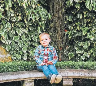  ??  ?? Smiling through: Alfie stays cheerful despite his persistent skin condition.