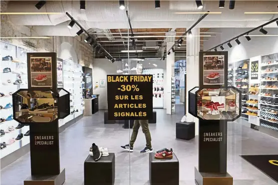  ?? — AFP ?? A shop window in Marseille, southern France, shows a poster announcing Black Friday sales on Nov 24.