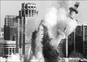  ??  ?? An abandoned television tower collapses during a controlled demolition in Yekaterinb­urg, Russia, on Saturday.