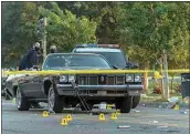  ?? DYLAN BOUSCHER / BAY AREA NEWS GROUP ?? Officers work the scene of a shooting Saturday in Oakland.