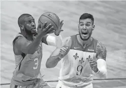  ?? GERALD HERBERT/AP ?? Suns guard Chris Paul (3) drives to the basket against Pelicans center Willy Hernangome­z. The Suns won 132-114.