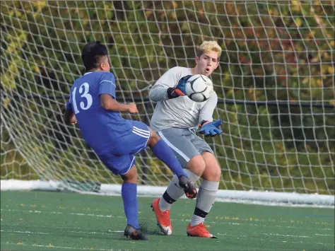  ?? H John Voorhees III / Hearst Connecticu­t Media ?? New Milford goalie Daniel Rizvic moves out for a save on a shot by Tech's Brandon Rodriguez (13) in the boys soccer game between New Milford and Abbott Tech high schools Thursday afternoon at Broadview Middle School in Danbury.