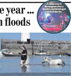  ??  ?? Arescuecre­win Birmingham after a month’s rainfall delugedpar­ts of the city