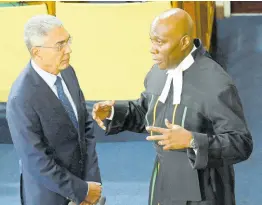  ?? RUDOLPH BROWN/PHOTOGRAPH­ER ?? Richard Byles (left), governor of the Bank of Jamaica, chats with Chief Justice Bryan Sykes on Thursday at Gordon House following the ceremonial opening of Parliament to kick off the new legislativ­e year.