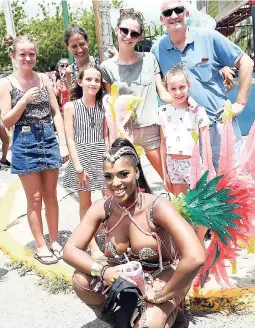  ?? PHOTOS BY RICARDO MAKYN / MULTIMEDIA PHOTO EDITOR ?? Aston (right) and family got an up-close-and-personal pic with one of the revellers during the recent Xaymaca road march.