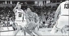  ?? Spurs and Feathers/ALLEN SHARPE ?? Arkansas forward Gabe Osabuohien (22) drives to the basket against South Carolina guard A.J. Lawson during the second half of the Razorbacks’ 77-65 loss to the Gamecocks on Saturday in Columbia, S.C.