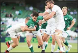  ??  ?? Ireland’s Joey Carbery, (centre), is tackled by USA’s Hanco Germishuys, (left) and Cam Dolan, (right), during the Rugby Union Internatio­nal Summer Series match between Ireland and USA, in Dublin, Ireland, on July 10. (AP)