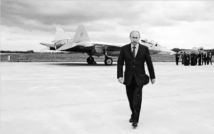  ?? ALEXEI DRUZHININ THE ASSOCIATED PRESS ?? Russian leader Vladimir Putin walks away from a new fighter jet after its test flight in 2010. Late last month, the Russian newspaper Izvestia reported that country’s military will resume fighter patrols to the North Pole for the first time in 30 years.