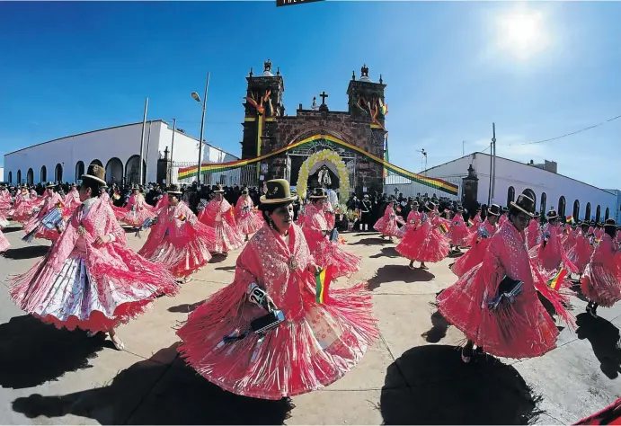  ?? Picture: David Mercado/Reuters ?? SPIN DOCTORS Dancers do the Morenada, a Bolivian folk dance, at a festival in Guaqui, on the shores of Lake Titicaca.