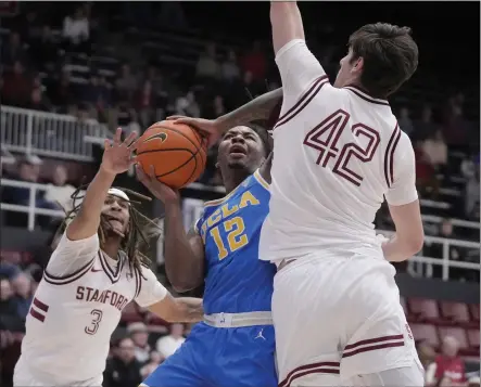  ?? JEFF CHIU — THE ASSOCIATED PRESS ?? UCLA guard Sebastian Mack, defended by Stanford's Kanaan Carlyle, left, and Maxime Raynaud, had 21points in the Bruins' win at Stanford.