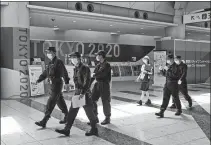  ?? JAE C. HONG / ASSOCIATED PRESS ?? Police conduct security checks on Monday at the main press center of the 2020 Tokyo Olympics.