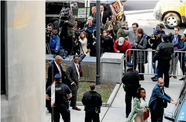  ?? PHOTOS: AP ?? Bill Cosby spokespers­on Andrew Wyatt holds his fist held high as he and the entertaine­r leave for the day from Cosby’s sexual assault trial at the Montgomery County Courthouse in Norristown, Pennsylvan­ia.