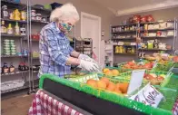  ??  ?? Beatrice Alcon, of Cleveland, shops for produce on sale at Los de Mora Local Growers’ Cooperativ­e.