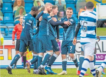  ??  ?? The bearded Iain Davidson is congratula­ted after scoring the game’s only goal