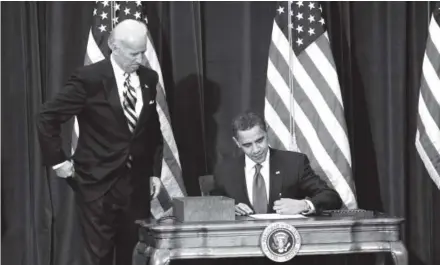  ??  ?? President Barack Obama signs the $836 billion economic stimulus bill in Denver on Feb. 17, 2009, at the Denver Museum of Nature and Science as Vice President Joe Biden looks on. Helen Richardson, Denver Post file