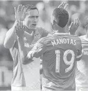  ?? David Zalubowski / Associated Press ?? The Dynamo’s Andrew Wenger, back left, is congratula­ted by teammates Mauro Manotas, front left, and Sheanon Williams after scoring in the first half.