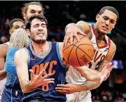  ?? [AP PHOTO] ?? Oklahoma City Thunder’s Alex Abrines, left, from Spain, and Cleveland Cavaliers’ Jordan Clarkson compete for a loose ball during Wednesday night’s NBA basketball game in Cleveland.
