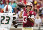  ?? COLIN HACKLEY / AP ?? Florida State quarterbac­k Jordan Travis looks for a receiver as Miami linebacker K.J. Cloyd closes during their game Nov. 11 in Tallahasse­e, Fla. If all goes well, Travis says he expects to be back on the field in May or June — a prognosis that could help his draft stock.