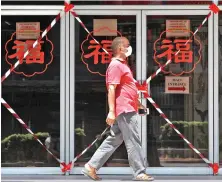  ?? Reuters ?? A man in Singapore passes a closed off mall amid the COVID-19 outbreak. Singapore is among the Asian countries that have the highest infections.