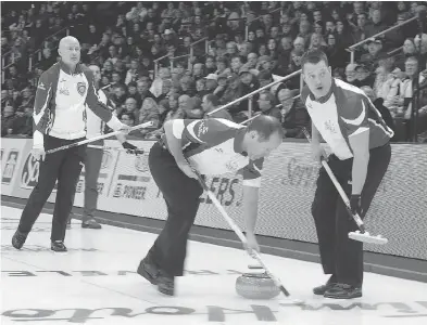  ?? ANDREW VAUGHAN / THE CANADIAN PRESS ?? Team Canada lead Ben Hebert, right, sat out the team’s game Tuesday morning at the Tim Hortons Brier with a possible torn meniscus. While the injury might require surgery, Hebert will return to action this week in St. John’s, Nfld.